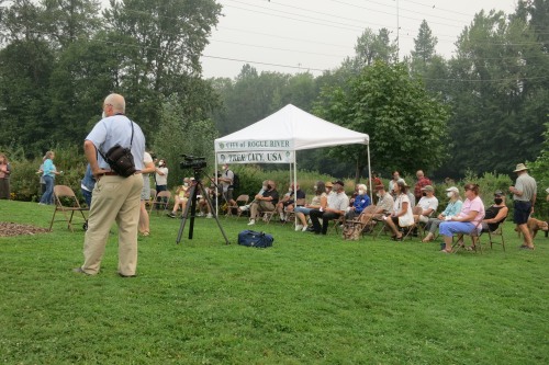 Audience in chairs on lawn and portable tent (City of Rogue River/ Tree City, USA)